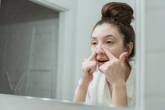 A woman washing her face with a mild cleanser to get rid of impurities on her face