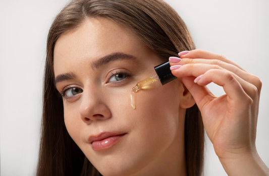 A girl applying a retinaldehyde serum on her face