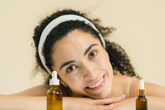 A woman posing with niacinamide & glycolic acid serums