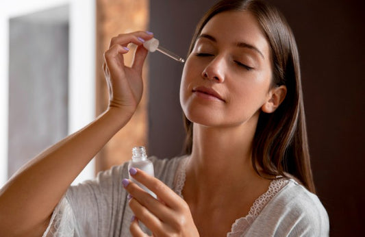 A woman applying retinaldehyde-infused serum to fight fine lines