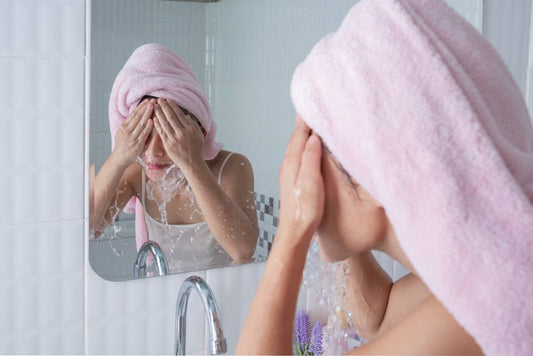 A woman cleansing her sensitive skin with a cream-based cleanser