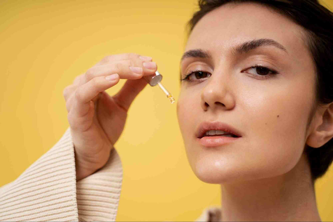 A woman applying a retinaldehyde serum on her face