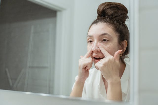 A woman washing her face with a mild cleanser to get rid of impurities on her face
