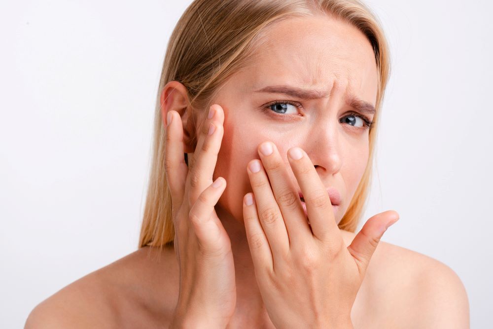 a woman having sensitive skin is worried
