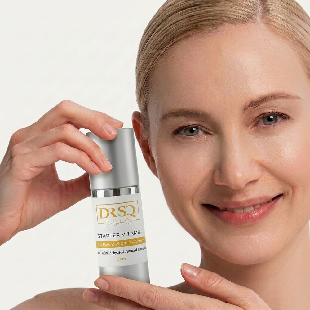 A middle-aged woman holding the bottle of Starter Vitamin A serum