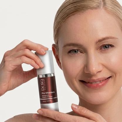 A middle-aged woman with fine lines is posing with DRSQ Pro Vitamin  A serum