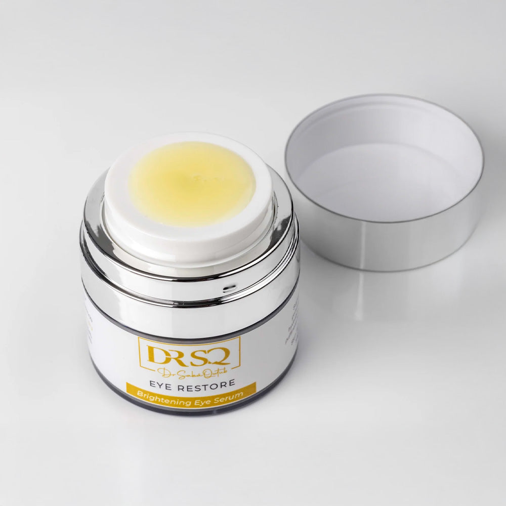 Eye Restore eye balm open jar kept on a plain surface